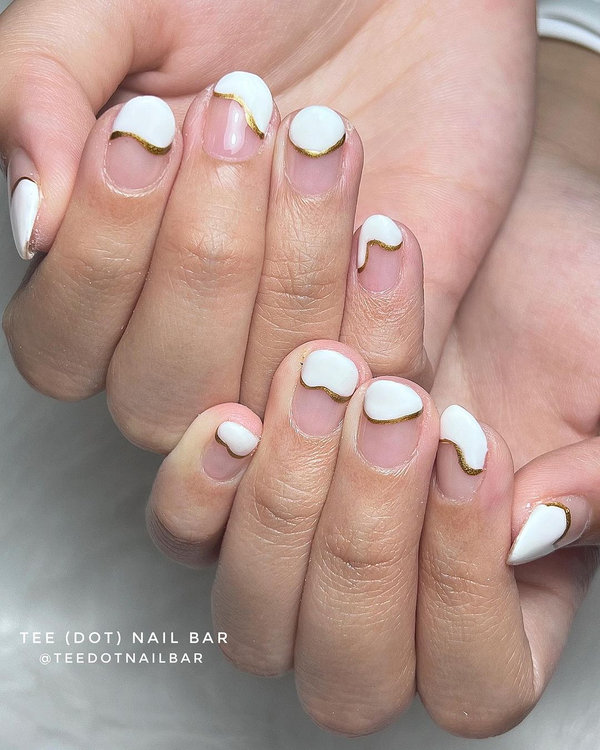 Modern French manicure with glitter tips and metallic stripe